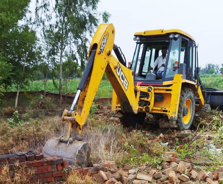 District town planner's team demolishing illegal construction in Barwasni.