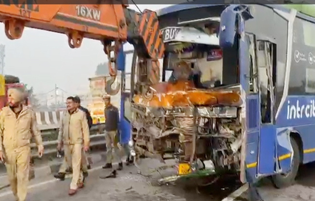 Bus collides with parked truck, conductor killed, six injured