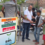 Fruits distributed to 1,800 needy children in memory of mother; inspiring message of service conveyed.
