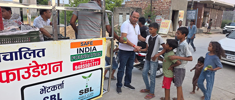 Fruits distributed to 1,800 needy children in memory of mother; inspiring message of service conveyed.