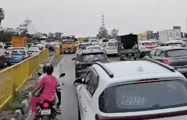 Youth climbs 250-foot-high electricity tower in Sonipat; highway jammed, power supply cut off.